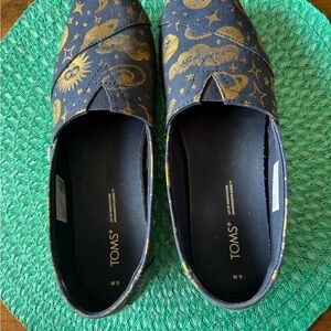 TOMS Women's Navy Slip-Ons with Gold Celestial Print
